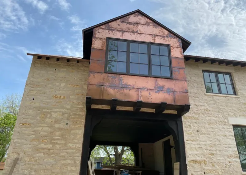 Copper metal panel facade on a stone building for Roof Repair in Mulvane