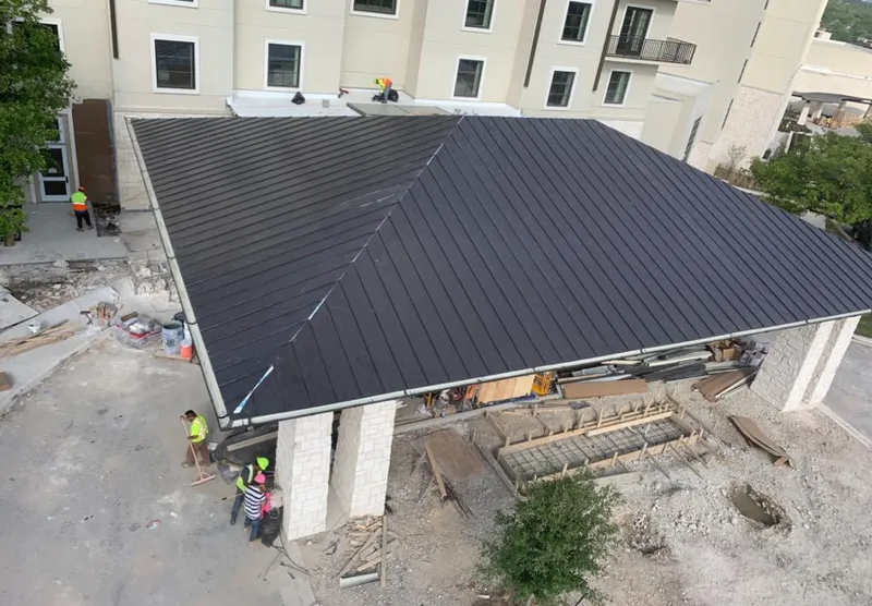 Metal roofing installation team working on a commercial building in Mulvane